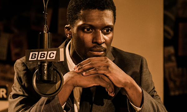 Marketing one night shows text on a pink banner with a sepia image of a young black man sat with his hands under his chin, behind him is a BBC sign