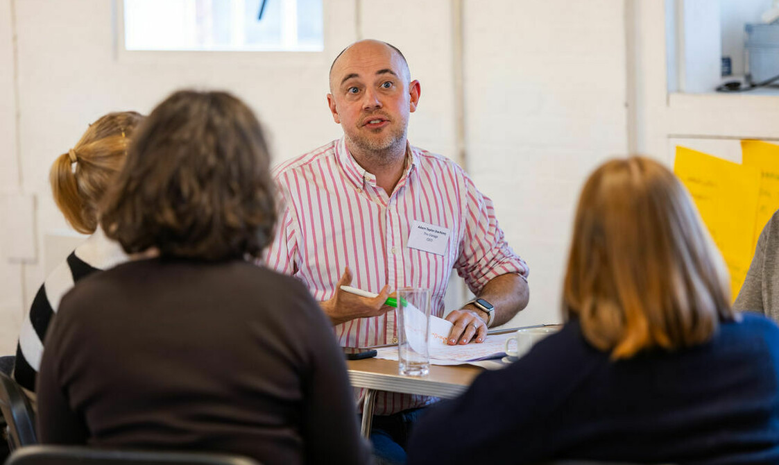 Adam from The Garage workshop talking with three other house network members