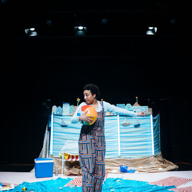 Performer in centre-stage of the blue set.