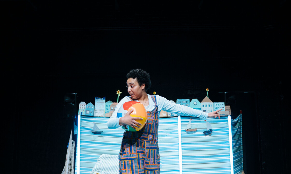 Performer in centre-stage of the blue set.