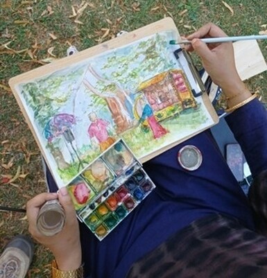 Artist hands, midst painting the Teabreak performance in watercolours