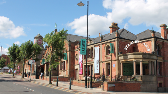 Outside of the Stanley Arts building with blue skies overhead