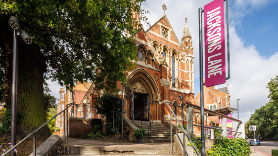 Outside shot of Jacksons Lane building, stairs lead up to a red brick building