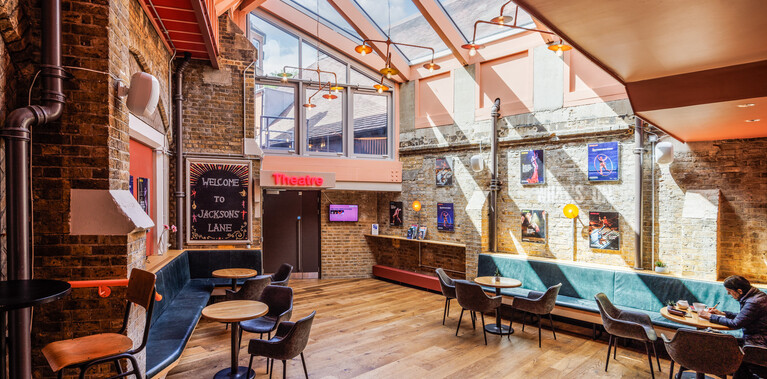 Jackson's Lane foyer space, glass ceiling with wooden floor and walls, light streaming in