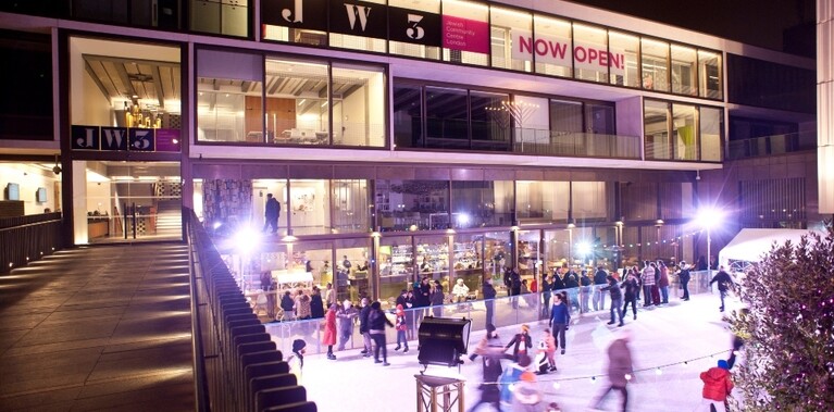 Glass fronted theatre building with JW3 in black lettering across the windows