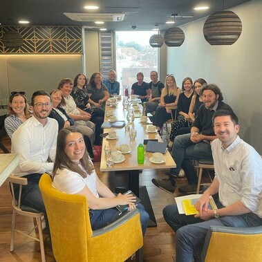 a group of people around a long table