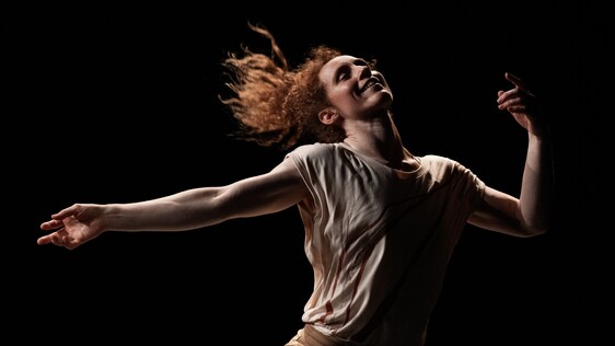 Nikki Rummer mid-dance with hair flowing and arms outstreched